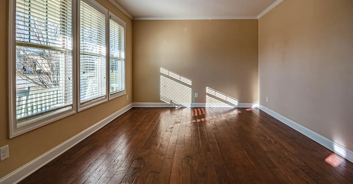 Sunlit empty room with hardwood floors and large windows, ideal for home staging.
